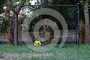 an old metal soccer goal with a soccer ball on it