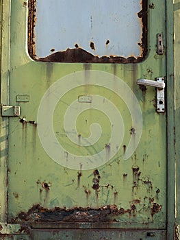 Old metal train door, green metal door, rusty door texture, train door background