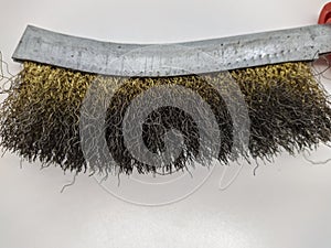 old metal wire brush for cleaning on a white background. wire brush for mechanical cleaning for metal.