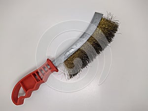old metal wire brush for cleaning on a white background. wire brush for mechanical cleaning for metal.