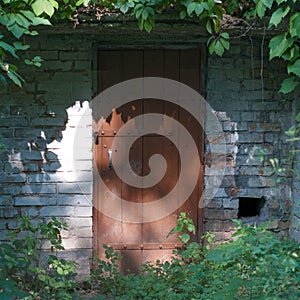 Old metal and wood door with a rusty lock