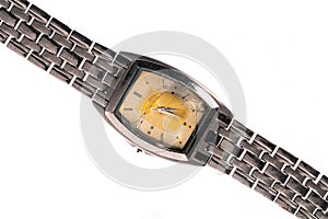Old metal wrist watch with damage dial on white isolated studio background. Broken retro watch with silver bracelet