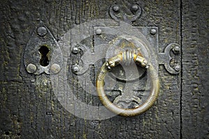 Old metalic latch on wooden door