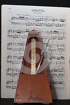 Old metronome with music in allegro photo