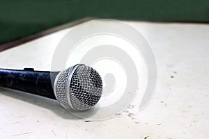 old microphone on white grunge table