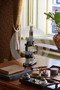 Old microscope on the desk of the doctor photo
