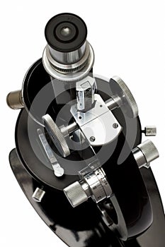 Old microscope on white background