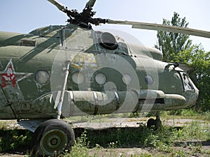 Old military abandoned helicopter. Broken non-working helicopter green