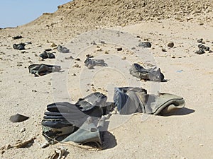 Old military army boots abandoned in remote african desert