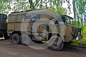 Old military truck parked near an old way.