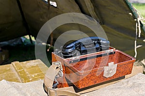 Old military wired phone stands on the table