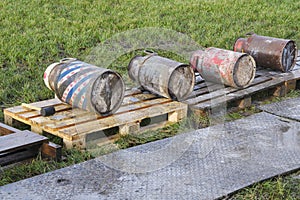 Old milk cans lying in a row during the carbide shooting tradition in the Netherlands