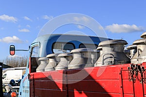 Old milk churns on vintage lorry