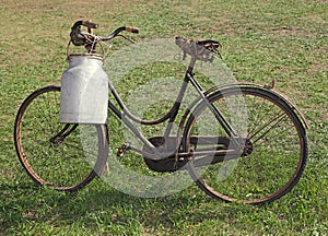 Old milking bicycle with aluminum milk canister to deliver milk