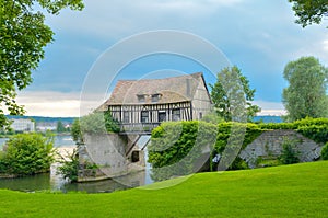 Old mill house on bridge, Seine river, Vernon, France