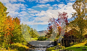 Old Mill Museum, water wheel, millpond and waterfall in historic Weston Village