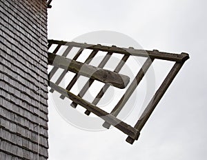 An old mill sheathed with wooden planks with blades. Historic site, close-up
