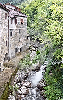 Old mill and stream. Times gone by. Picturesque stone buildings.