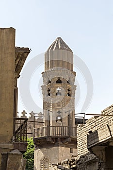 Old minaret of mosque against a bright blue sky, Islamic Cairo.