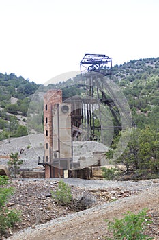 Old mine headframe among the trees photo