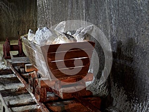 Old mine wagon with illuminated salt stones in Turda salt mine