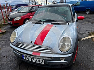 Old Mini Cooper in bad condition for sale at local car dealer.