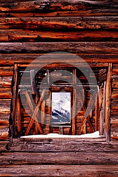 Old Mining Log cabin with mountian view through wi