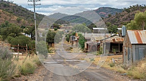 An old mining town now abandoned with dilapidated buildings and rusted machinery tered throughout. Despite the decay the