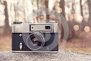 Old 35mm camera in the forest