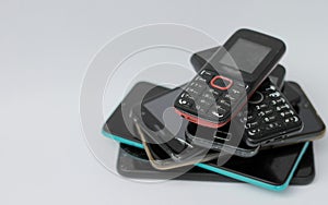 old mobile phones piled up on a table with no people stock image stock photo
