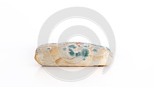 Old moldy bread on white background