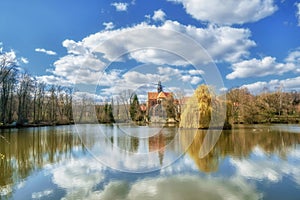 An old monastery in an idyllic atmosphere on a lake in sunshine