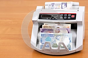 Old money from Madagascar in a counting machine