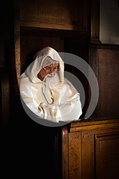 Old monk in dark church