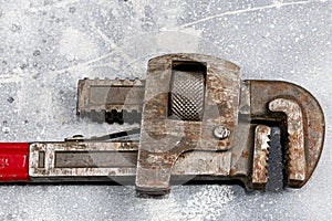 Old Monkey wrench isolated on cement background