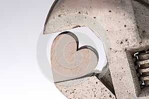 Old monkey wrench and wooden heart