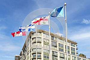 Old Montreal modern building with four flags