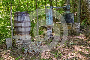 Old moonshine still hidden in the woods photo
