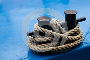 Old mooring bollard with heavy ropes