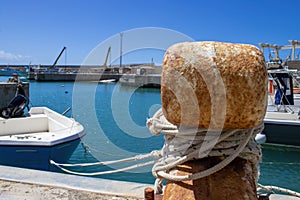 Old Mooring Bollard with rope Tied on Pier. Boat Tied With a Rope on a Mooring