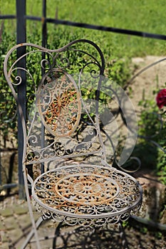 Old more rusty, more romantically, chair from metal,