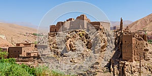 Old Moroccan clay kasbah perched on hill in Atlas mountains, Morocco, North Africa