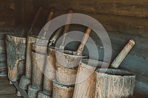 Old mortars with pistils in them. Old home utensils  for grains grinding photo