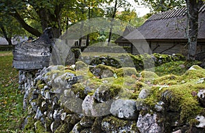 Old mossy stonewall and fishingboat