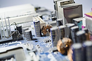 The old motherboard from the PC. Blue color. Dust. Repair of the computer. Modern technologies. Workshop.