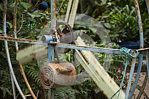 Old motor and big steel fan at outdoor for blowing cool down to travelers people in orchard garden