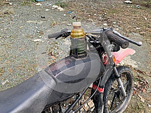 an old motorbike with a modified gas tank using an old bottle