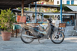 Old motorbike is staying near street cafe