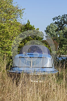 Old motorboat lying on a meadow, Varel harbor, Varel, Lower Saxony