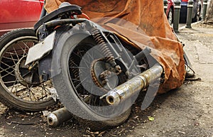 Old motorcycle covered with canvas